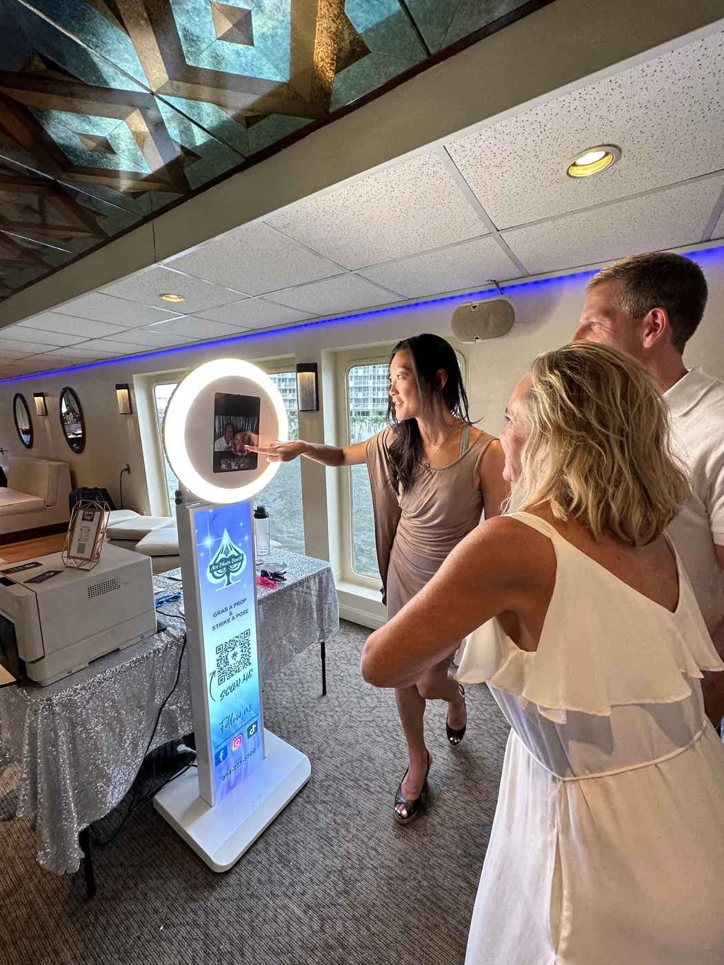 Guests using a ring-light digital selfie booth at a private event