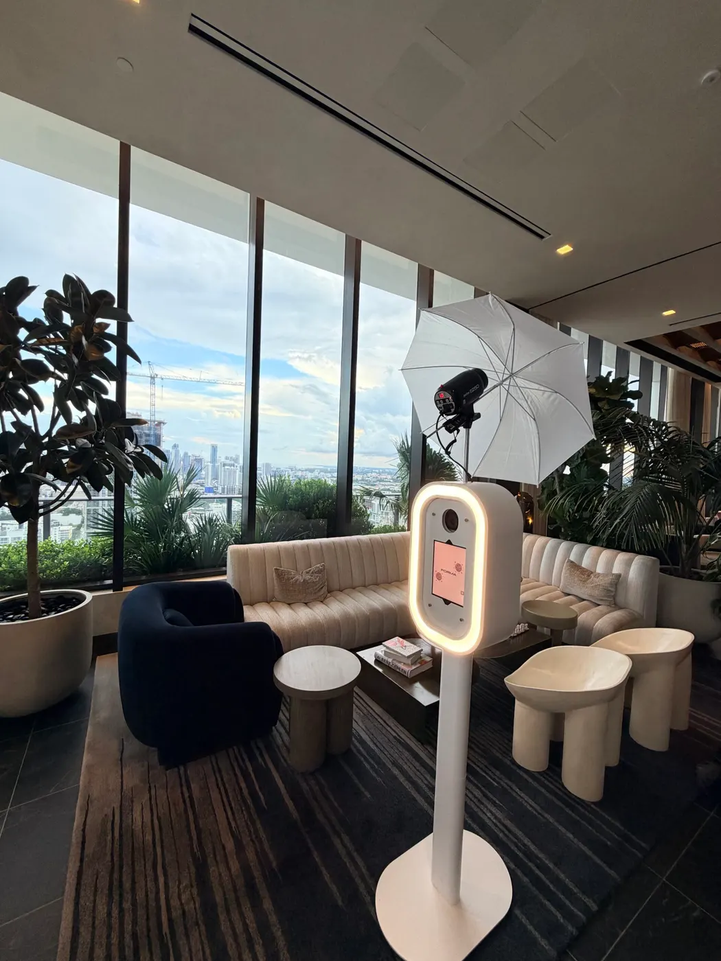 Digital photo booth with studio lighting set up in a modern event lounge with city views